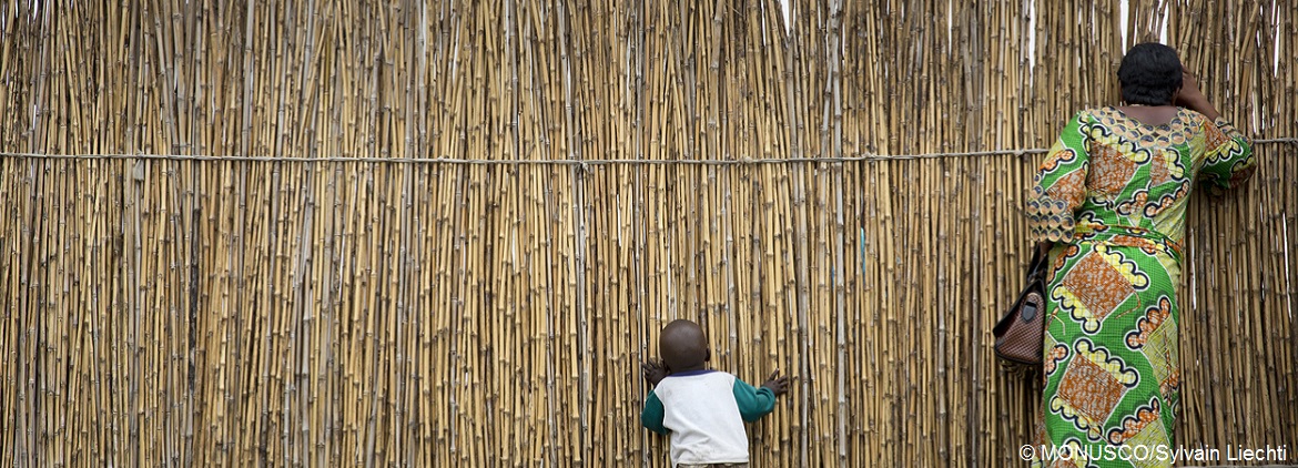 Woman child look through a bamboofence MONUSCOPhotos cc